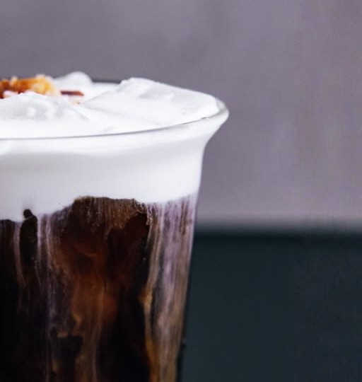 Cold foam settled thick on a dark iced drink